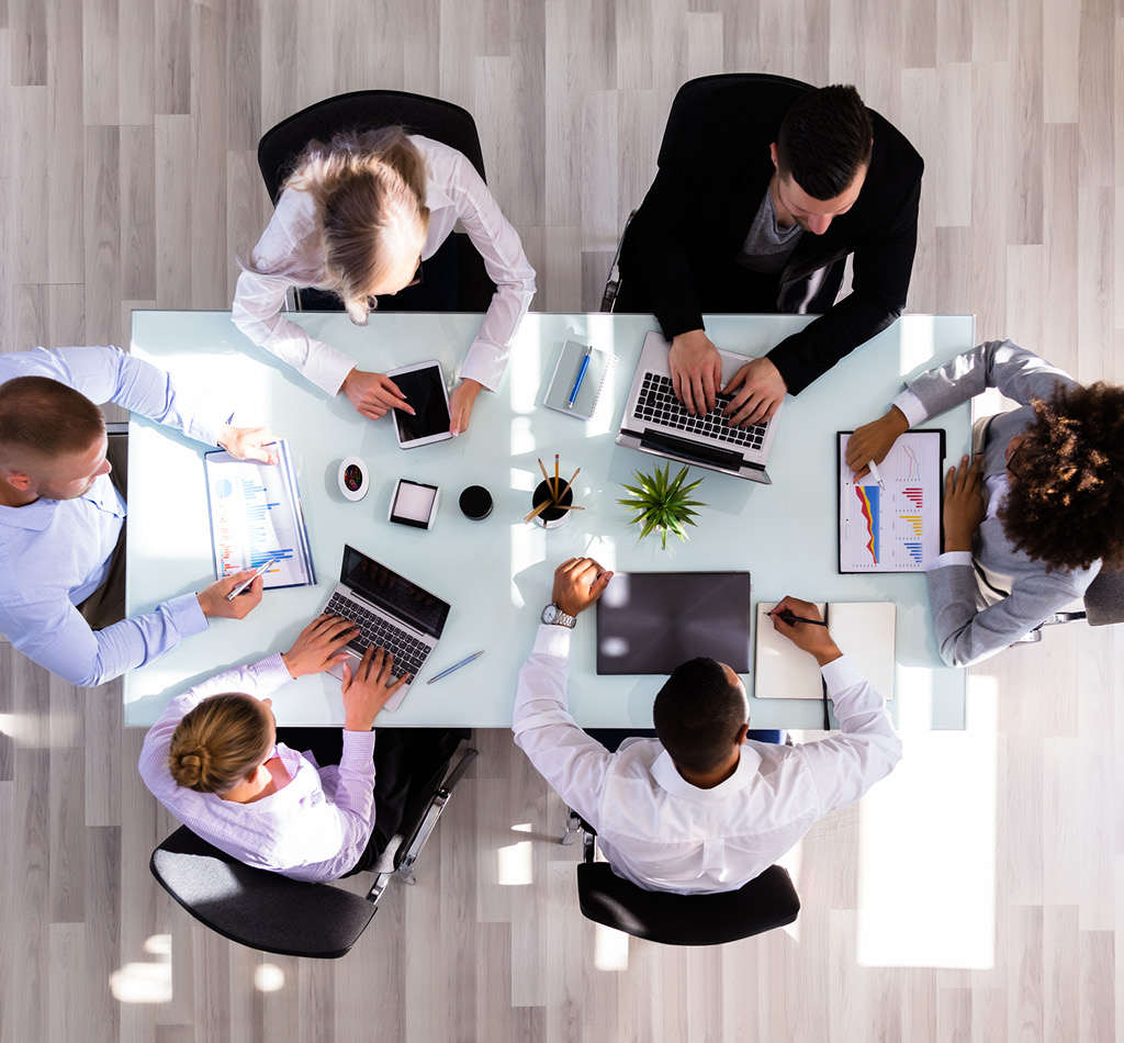 Top-down view of businesspeople working in office.